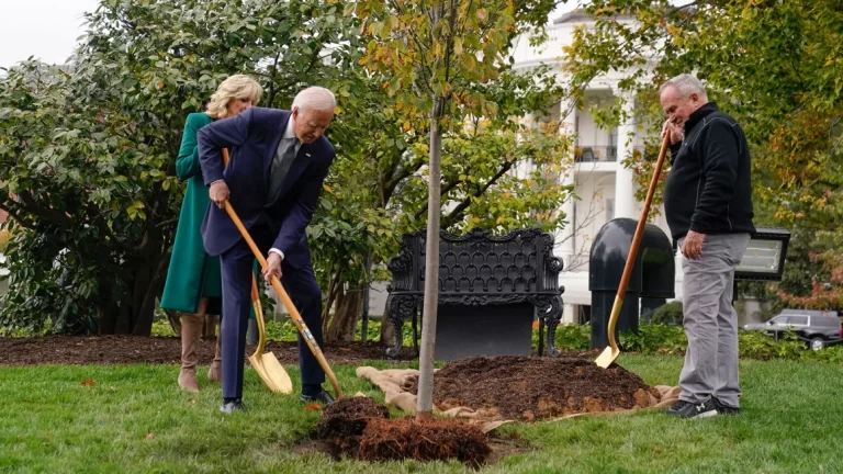 An image of President Joe Biden and first lady Jill Biden planting a tree