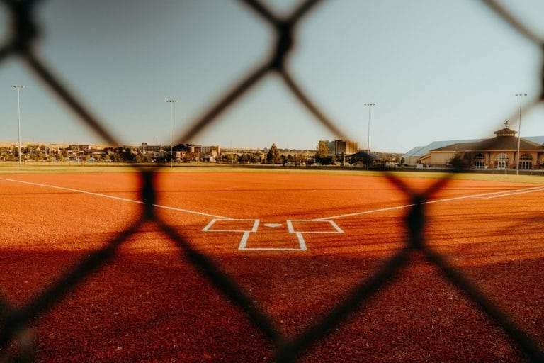 A home plate umpire crouched behind a catcher during a spring training baseball game.