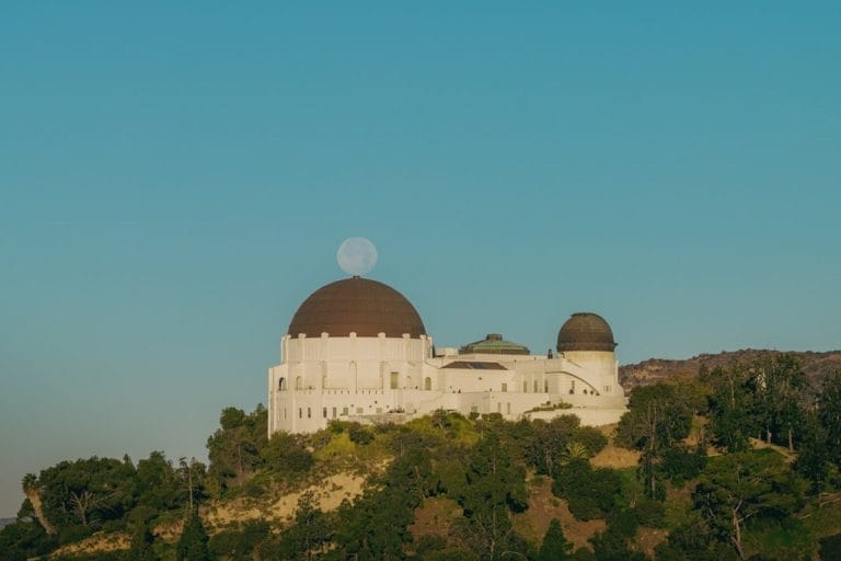 A telescope observatory dome silhouetted against a star-filled night sky.