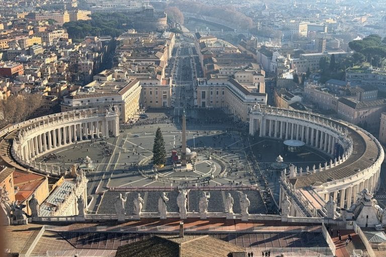 A crowd gathered in St. Peter's Square at the Vatican looking toward the basilica.