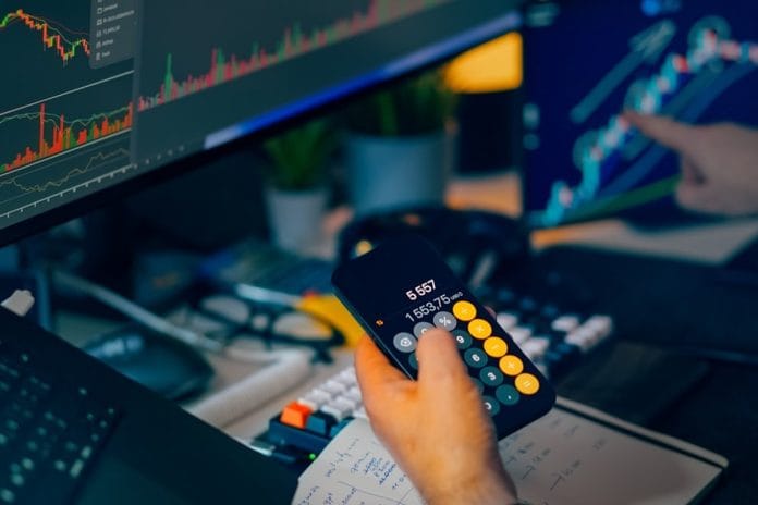 Trading Desk on Jobs Report Morning A bond trader's cluttered desk with multiple monitors during the morning jobs report release
