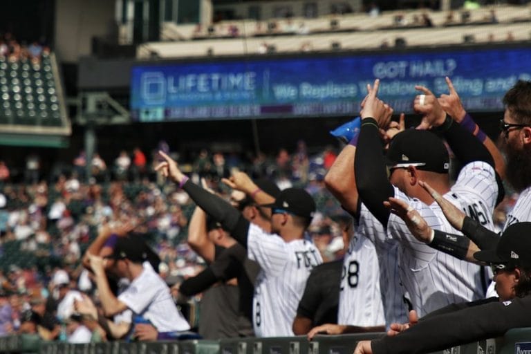 Players celebrating in a Major League Baseball dugout during a postseason game