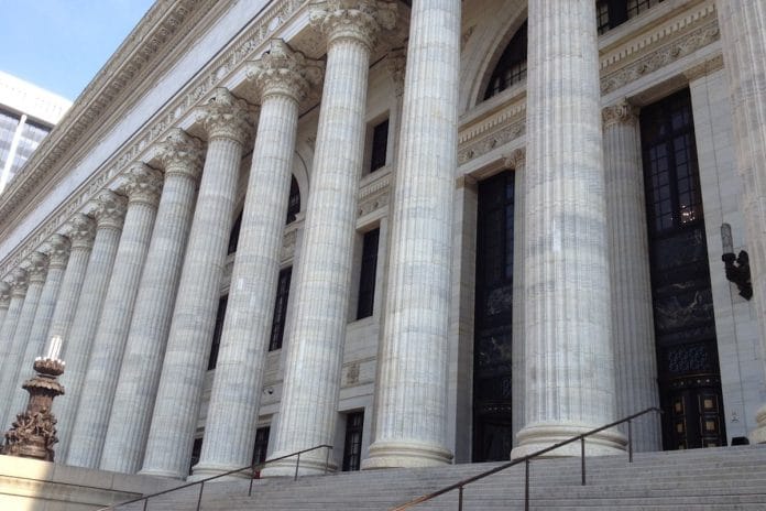 The exterior of a federal courthouse on an overcast fall afternoon, with steps and columns visible.
