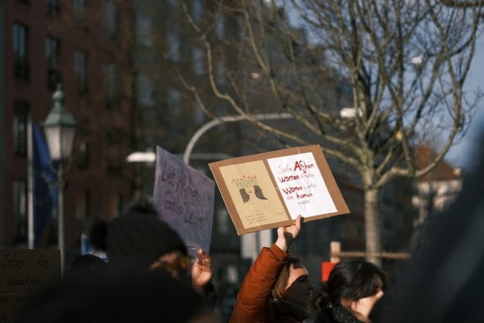 Saturday's March on Connecticut Avenue A large, orderly weekend protest march moving through a city street in winter, marchers in heavy coats carrying handmade signs.