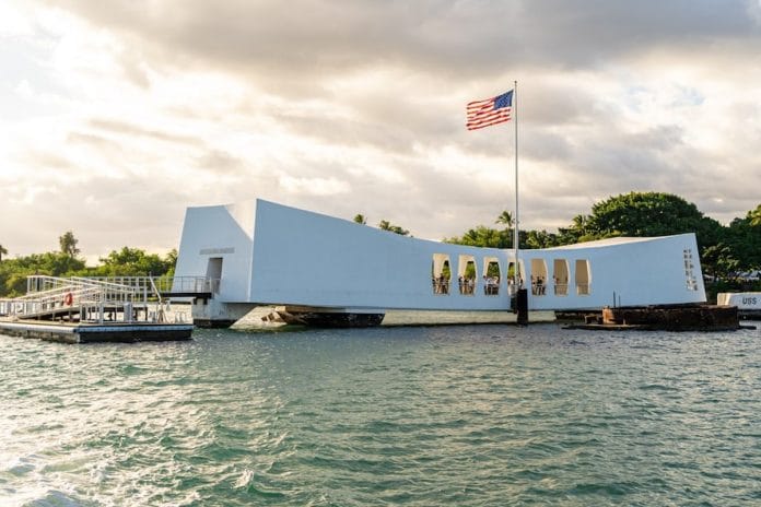 USS Arizona Memorial, Pearl Harbor The USS Arizona Memorial at Pearl Harbor, with a wreath placed near the railing overlooking the water.