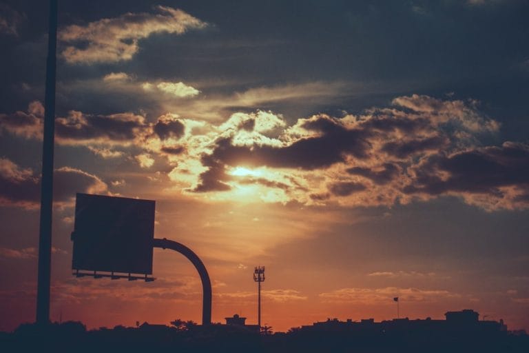 An NBA arena interior with the scoreboard lit above an empty court